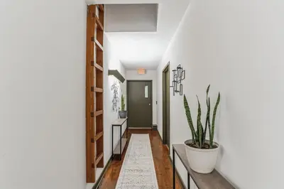 a hallway with white walls and a potted plant at Overlook Brandywine Valley in Thornton