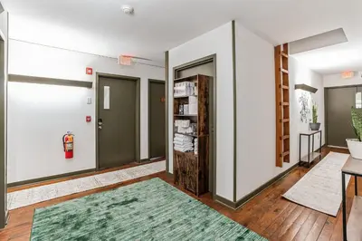 a hallway with two doors and a green rug at Cozy retreat in Thornton PA in Thornton