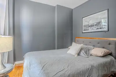 a bedroom with a bed with two pillows on it at Chic 3Bd NoMad Manhattan in New York