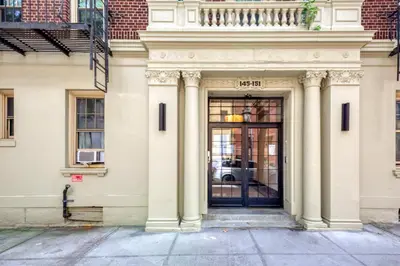 a white building with a door with a balcony at Brooklyn Heights 2br w elevator wd NYC-1066 in Brooklyn