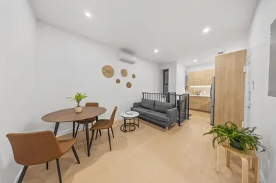 a living room with a couch and a table at Private Room with Shared Bathroom at an Apartment by Times Square in New York