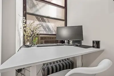 a desk with a computer and a window at Steps from Everything - Modern 1-Bdr in Downtown's Union Square in New York