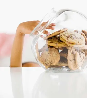 a person holding a glass container filled with cookies at Parkview Inn & Suites, Lancaster Amish Country, PA in Lancaster
