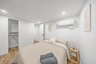 a white bedroom with a bed and a window at Oasis Room at a Shared Apartment by Times Square in New York