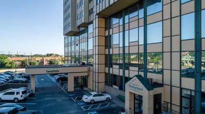 a building with cars parked in a parking lot at PP 514 City Chic in a Modern Studio Haven in Harrisburg
