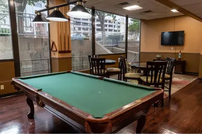 a pool table in a room with chairs and a tv at PP 2114 Professional 2br apt, Near Hospitals in Harrisburg