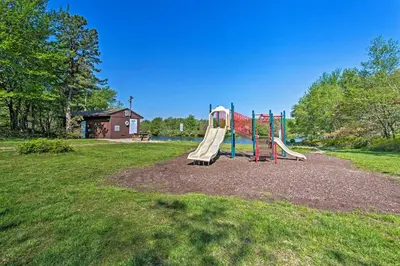 a playground with a slide in a park at 9 Mi to Camelback! Home with Hot Tub and Fire Pit in Long Pond