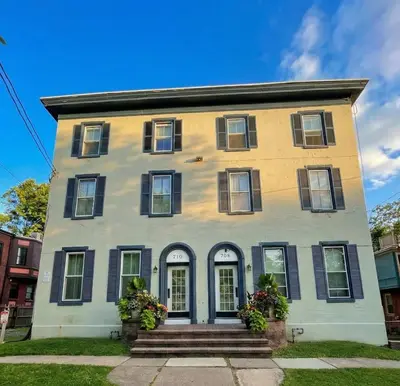 a yellow and white house with black windows at The Terrace at Park Place 2nd floor walk up -cozy 2 bedroom fast WiFi free coffee in Wilmington