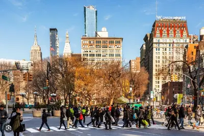 a group of people crossing a street in a city at Oasis Apartment in the Heart of Union Square Downtown Manhattan in New York