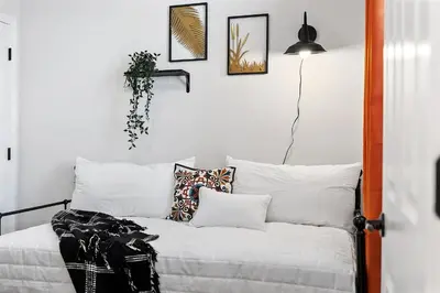 a room with a bed with pillows and a lamp at Fitler Square GEM - 3 Bedrooms in Philadelphia