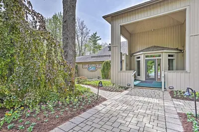 an exterior view of a house with a driveway at Game Room and Fire Pit Chic Pocono Pines Home! in Pocono Pines