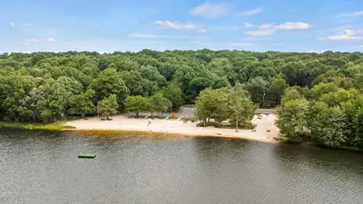 an aerial view of an island in the middle of a lake at 7mins to Skiing Fire Pit Game Table Lake Access Hygge Home by AvantStay in Blakeslee