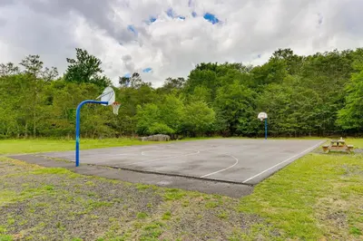 a basketball court with a hoop in a park at Tobyhanna Home with Fire Pit 1 Mi to Lake Carobeth! in Tobyhanna