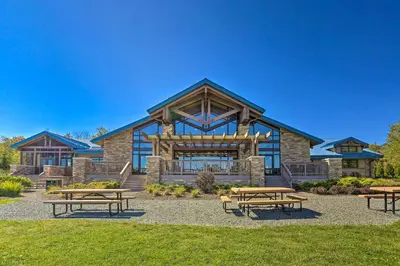 a building with picnic tables in front of it at Pocono Lake House Hideaway Hot Tub and Theater Room in Pocono Lake