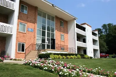 an apartment building with flowers in front of it at Spacious Retreat I Balcony I Parking I Chateau in Wilmington