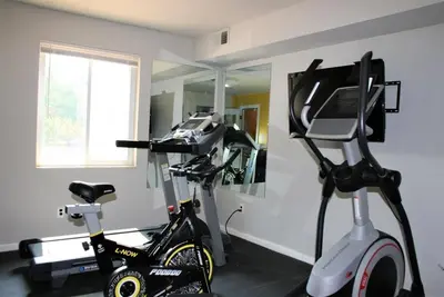 a room with a treadmill and an exercise bike at Historic Charm Meets Modern Comfort The Chateau in Wilmington