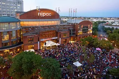 a large crowd of people in front of a building at Comfy Cozy retreat - NYC & NWK w free parking in Bayonne