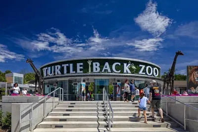 a group of people standing in front of a turtle back zoo at Home Sweet Home - near NWK & NYC w/free parking in Newark