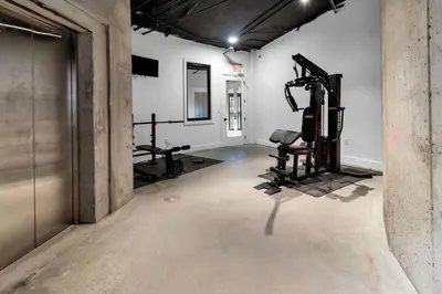 an empty room with a gym with two tread machines at Pink Heaven Indoor Pool, FREE Parking, Near NYC in Elizabeth