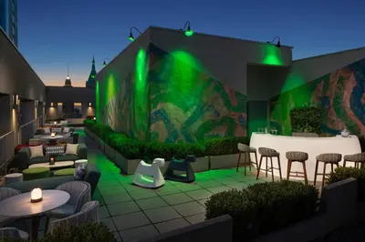 a restaurant with a green wall with tables and chairs at Tribeca 1br w doorman gym roof deck NYC-1374 in New York