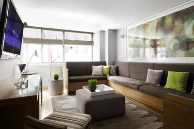 a living room with a couch and a tv at Chelsea 1br w roofdeck gym nr Flatiron NYC-1384 in New York