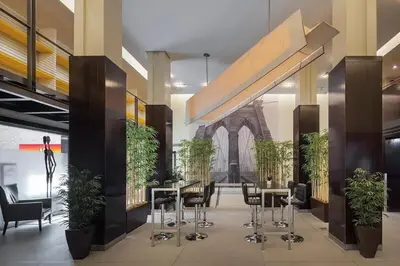 a lobby with tables and chairs and a building at 73-703 New Studio UWS Doorman Gym in New York