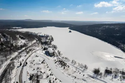 an aerial view of a river with snow and trees at The Best of Blakeslee in Blakeslee