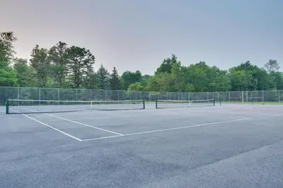 a tennis court with two tennis rackets on it at Forest Views and Hot Tub Poconos Cozy Cabin in Albrightsville
