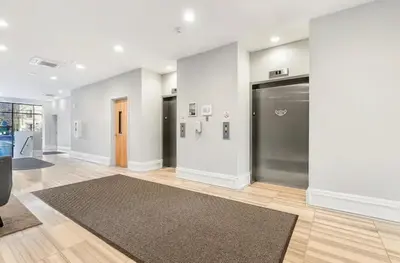 a living room with a door and a rug at Luxury 1BR - Glass Wall & Window in Philadelphia