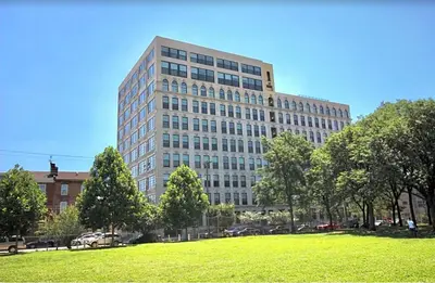 a tall building with a green field in front of it at Luxury 1BR - Glass Wall & Window in Philadelphia