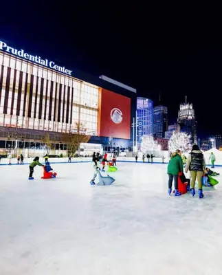 a group of people on an ice rink in front of a building at Belmont Suites - BR 2 (Private Room) - 30 mins to NYC in Newark