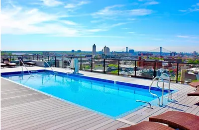 a swimming pool on the roof of a building at Glam Flat with View, Pool, Deck in Philadelphia