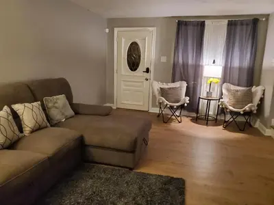 a living room with a couch and chairs and a table at Harmony Room with private bathroom by the Airport in Darby