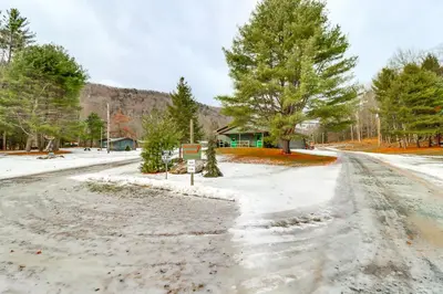 a snow covered road with trees and a house at Private Hot Tub Main Cabin at Elk Creek Escape! in Hillsgrove