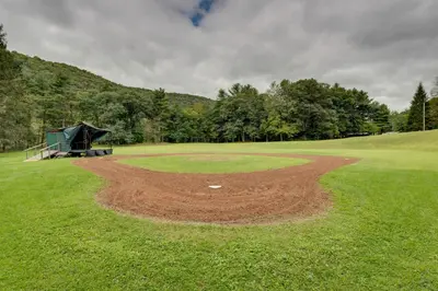 a dirt pitchers mound on a golf course at Community Perks Elk Creek Escape - Deluxe Cabin C in Hillsgrove