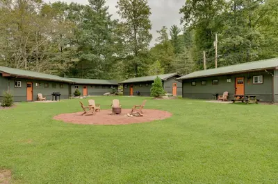 a yard with two chairs and a picnic table at Deluxe Cabin G 9 Mi to Worlds End State Park! in Hillsgrove
