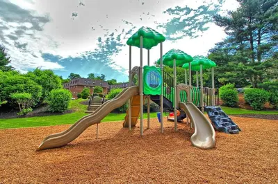 a playground with slides and umbrellas in a park at Pine Brook 1019 I Modern 15Br Apartment ! Pool in Newark