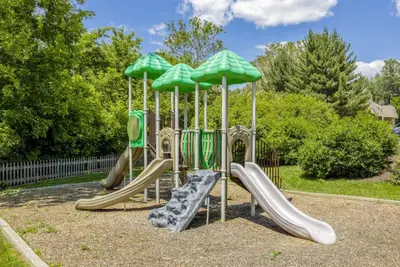 a playground with slides and umbrellas at Pine Brook 1108 I Pool Gym I Free Parking ! in Newark