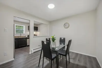 a dining room and kitchen with a table and chairs at Pine Brook 120 I Pool Gym I Free Parking ! in Newark