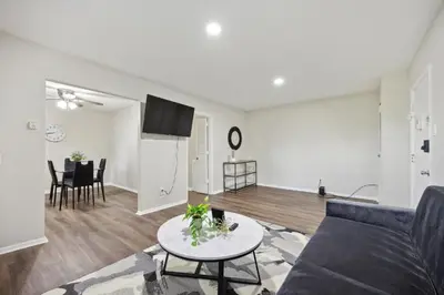 a living room with a couch and a table at Pine Brook 1202 I Pool Gym I Free Parking ! in Newark