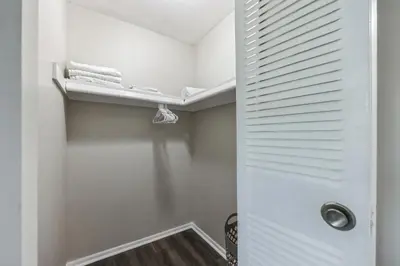 a walk in closet with a white door and a shelf at Pine Brook 1202 I Pool Gym I Free Parking ! in Newark
