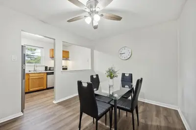 a dining room with a table and chairs and a clock at PineBrook 1406 I 2br Garden Style Apartment ! in Newark