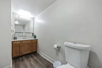 a bathroom with a toilet and a sink and a mirror at PineBrook 1406 I 2br Garden Style Apartment ! in Newark
