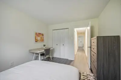 a white bedroom with a desk and a bed at Pine Brook 410 I Pool Gym I Free Parking ! in Newark
