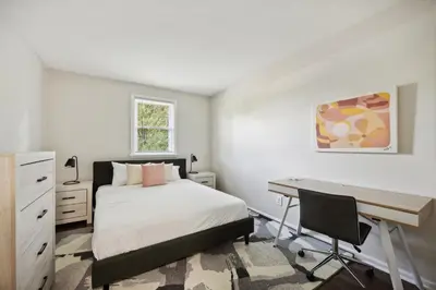a bedroom with a bed and a desk and a desk at Pine Brook 502 I Pool Gym I Free Parking ! in Newark