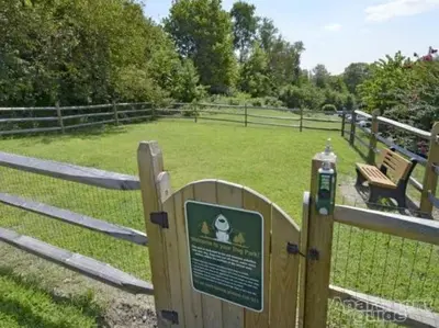 a park with a fence and a sign in a field at Pine Brook 817 I Corporate 1Br Apartment ! in Newark