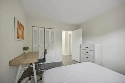 a white bedroom with a desk and a bed at Pine Brook 818 I Pool Gym I Free Parking ! in Newark