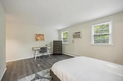 a white bedroom with a bed and a desk at PineBrook 914 I Popular 2Br Apartment for rent ! in Newark