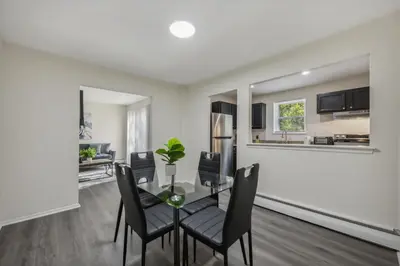 a dining room and living room with a table and chairs at PineBrook 914 I Popular 2Br Apartment for rent ! in Newark