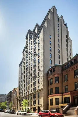 a tall building with a red car parked in front of it at 73-518 Newly Reno Studio UWS Doorman Gym Laundry in New York